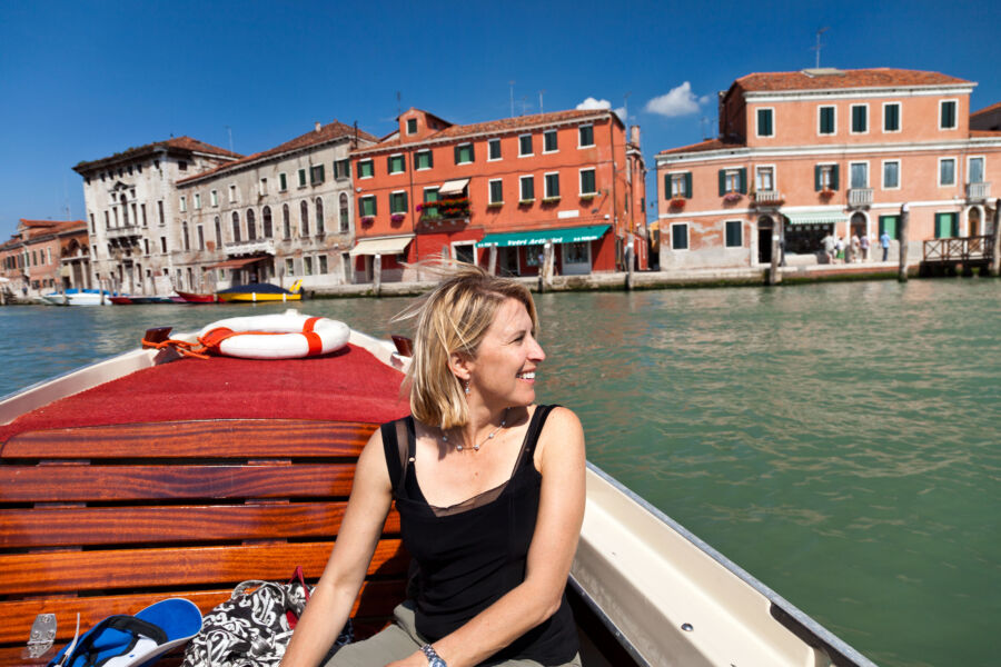 A woman aboard a boat in Venice.