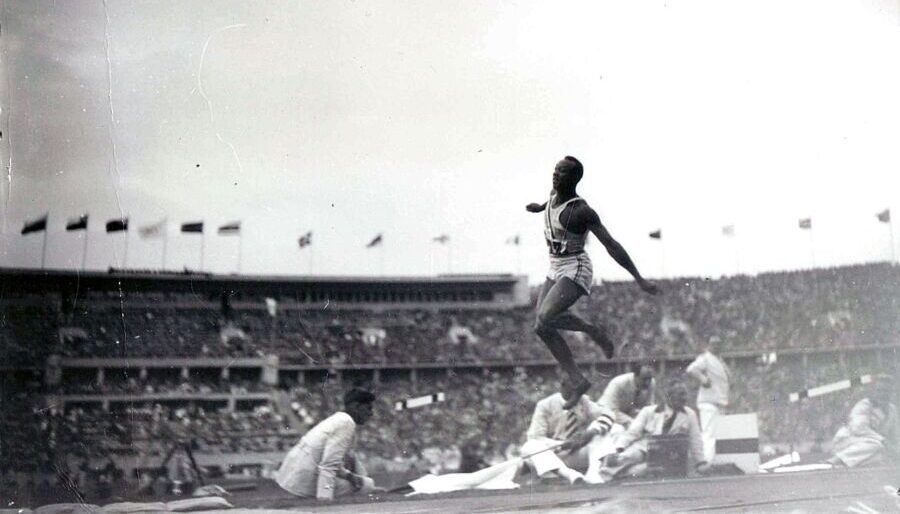 Jesse Owens participating in the long jump