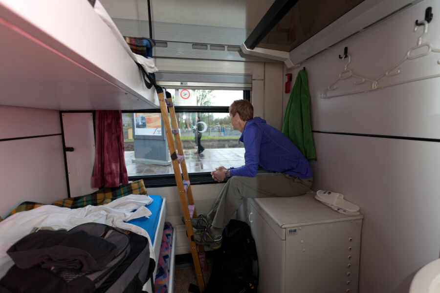 A woman in an overnight compartment on a train.