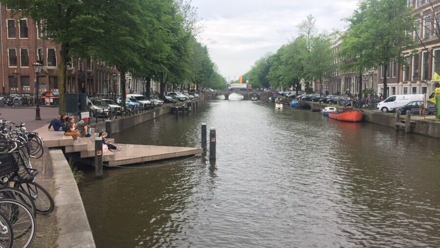 A triangular chunk of concrete juts into a canal in Amsterdam