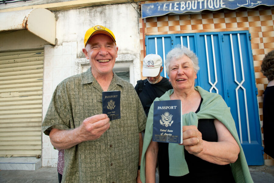Two people holding up American passports
