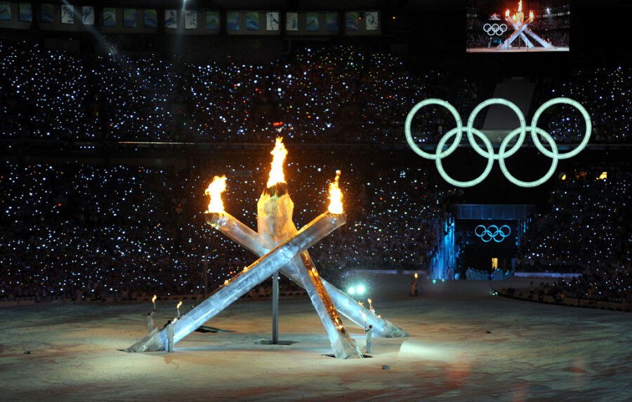 Ice luges with flames atop them, set beneath the Olympic rings