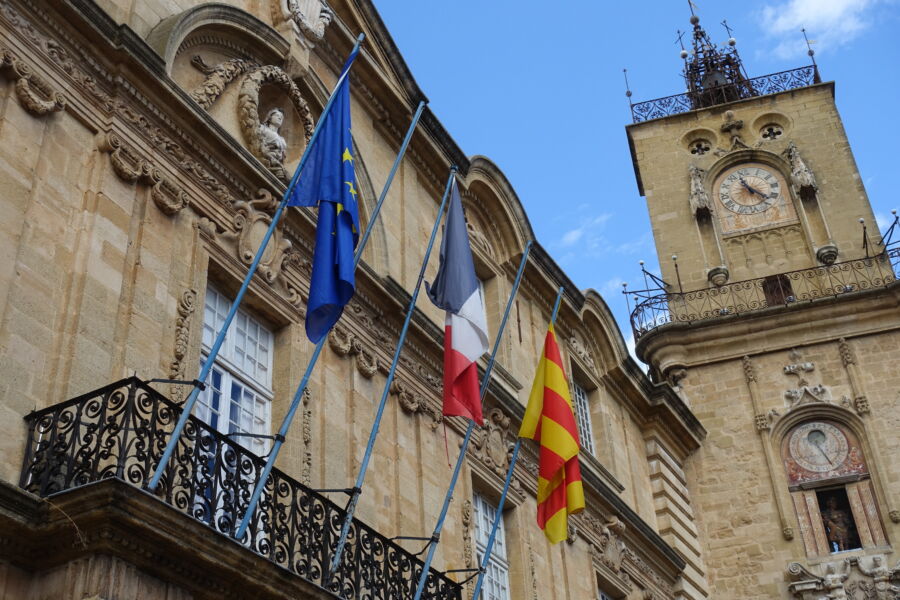 A city hall in Provence, France flies three flags: Europe, France, and Provence.