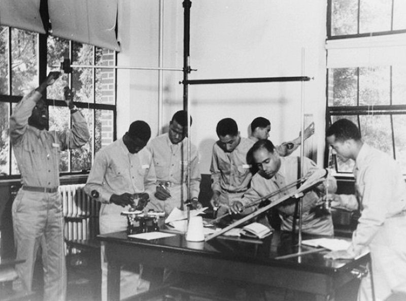A group of the Tuskegee Airmen working in a classroom