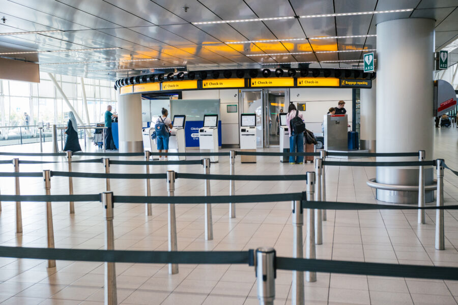 Stanchions at an airport, with no line.