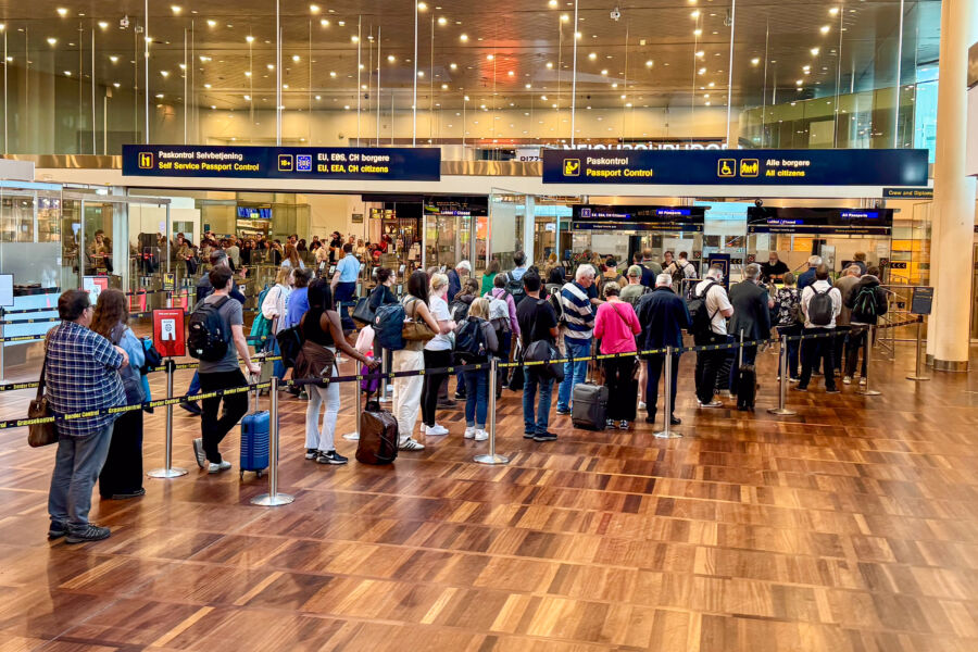 People waiting in an immigration line at an airport.