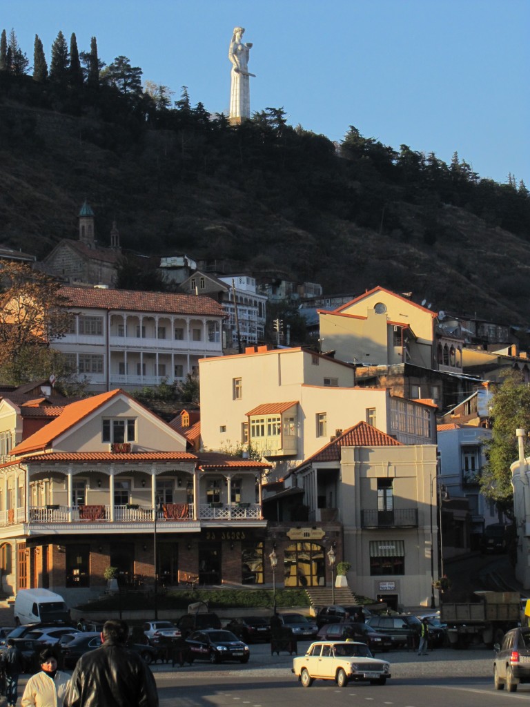 Mother Georgia overlooking her city with a bowl of wine for her guests and a sword for her enemies.