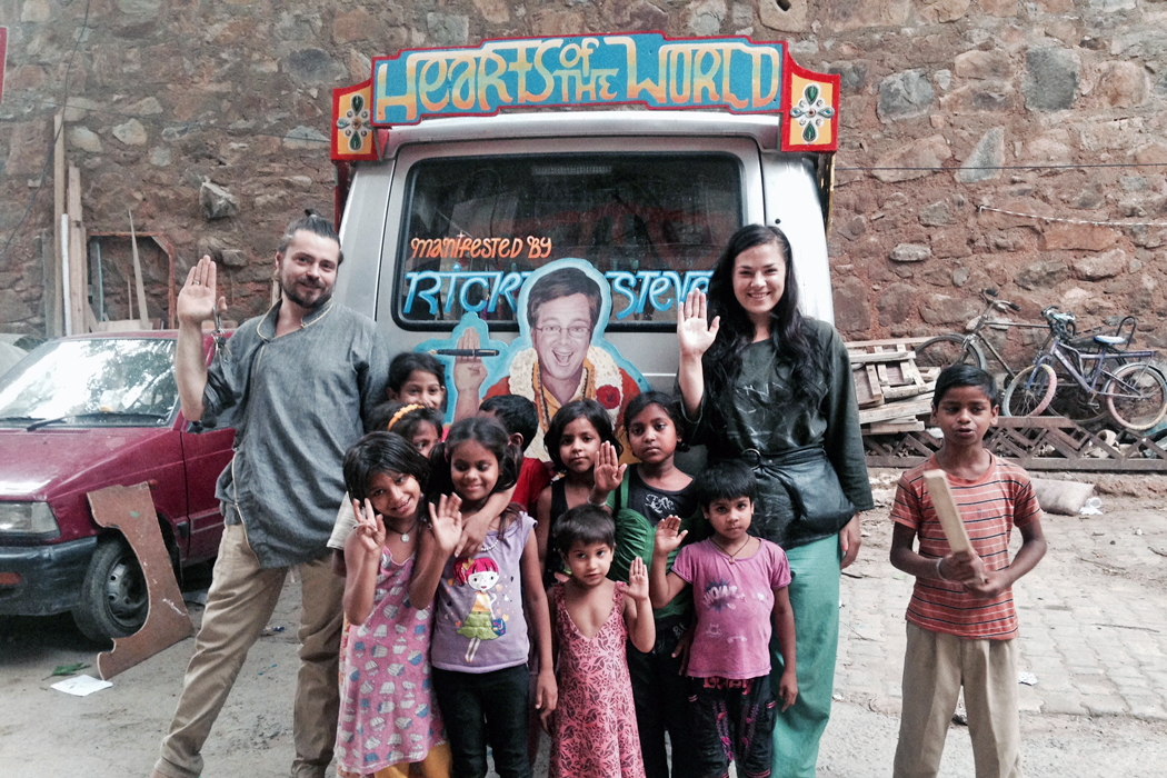 Nicolina and Orien pose with their van alongside Indian children