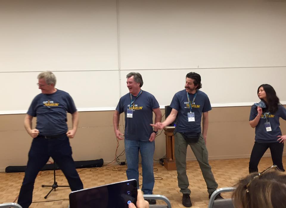 Four people wearing Rick Steves t-shirts