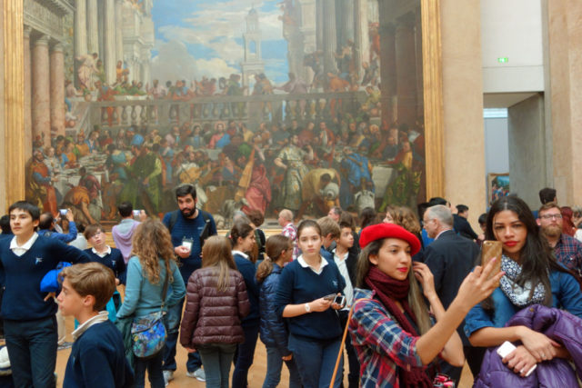 woman taking selfie in front of art