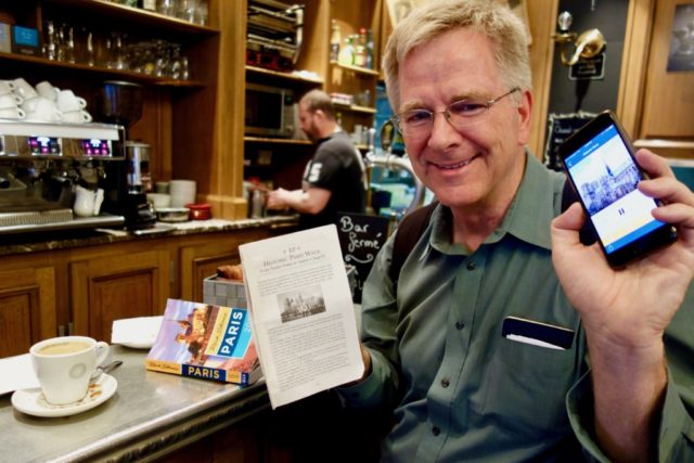 Rick Steves with iPhone and book
