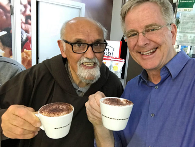 Rick Steves drinking a cappuccino with a monk