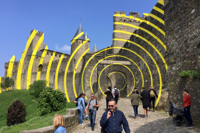 bright yellow concentric lines painted on medieval carcassonne tower