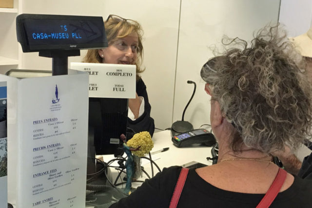cashier with a sign that says "sold out" in a few languages